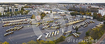 Cityscape panorama. Bird's eye perspective over half-filled bus terminus. Coaches and electrical busses standing Stock Photo