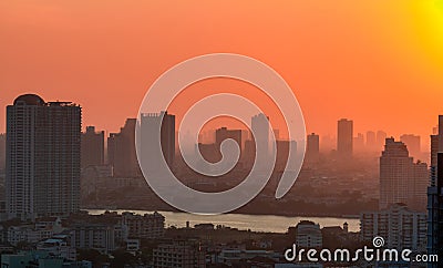 Cityscape with polluted air. Air pollution. Smog and fine dust covered city in the morning with orange sky. Environmental problem Stock Photo