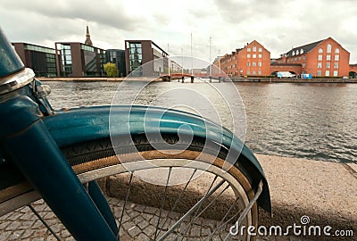 Cityscape with river, old buildings and parked bicycle in Copenhagen, Denmark. Danish capital with cycles, water chanel Stock Photo