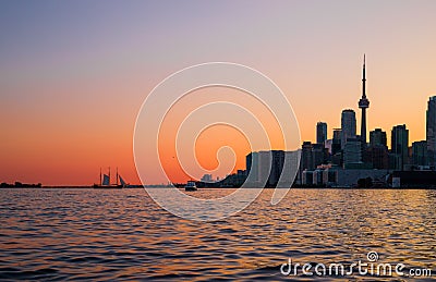 Cityscape - silhouettes of skyscrapers, calm lake old sail ship and yacht. Stock Photo