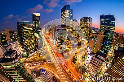 Cityscape of South Korea. Night traffic speeds through an intersection in the Gangnam district of Seoul, Korea. Stock Photo