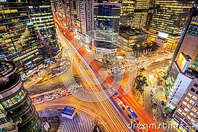 Cityscape of South Korea. Night traffic speeds through an intersection in the Gangnam district of Seoul, Korea. Stock Photo
