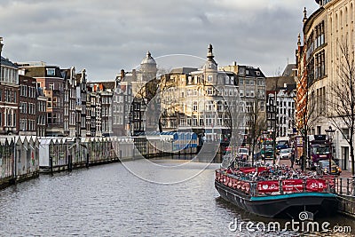 Cityscape - view of Bloemenmarkt flower market floating on barges, the Singel canal, city of Amsterdam Editorial Stock Photo