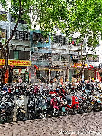 Cityscape view of old residential building and bike parking in Sanya city on Hainan island, China Editorial Stock Photo