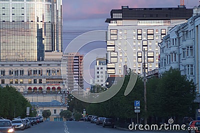 Cityscape: view from the street of Pushkin. Sunset colors the sky and glass of buildings. Editorial Stock Photo