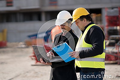 Civil engineer giving instructions to construction worker Stock Photo