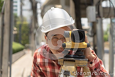 Civil engineer land survey with tacheometer or theodolite equipment..worker Checking construction site on Stock Photo