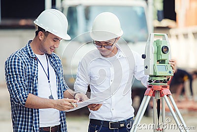 Civil Engineers At Construction Site and A land surveyor using a Stock Photo