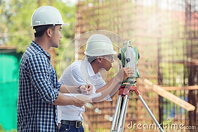 Civil Engineers At Construction Site and A land surveyor using a Stock Photo