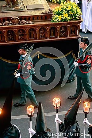 Civil guards dressed in uniform guarding a step in the Easter Week Procession of the Brotherhood of Jesus in his Third Fall on Hol Editorial Stock Photo