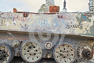 Civilian car shot by Russian soldiers. War in Ukraine. Destroyed russian tank on the Mykhailivs'ka Square. Editorial Stock Photo