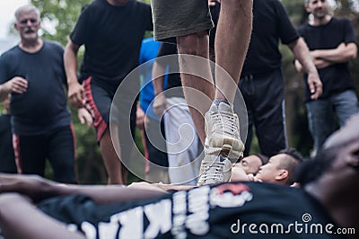 Civilian people trample over crowd lie on ground. Boot camp Editorial Stock Photo