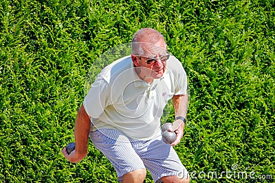 Older man plays pÃ©tanque. Editorial Stock Photo