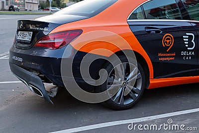 A CLA 200 car Mercedes Benz from car sharing company `Belka car` on toll parking. Rear bumper fell off after a traffic accident. Editorial Stock Photo