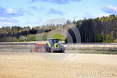 Claas Arion 650 Tractor and Vaderstad Rapid Seed Drill in Field Editorial Stock Photo