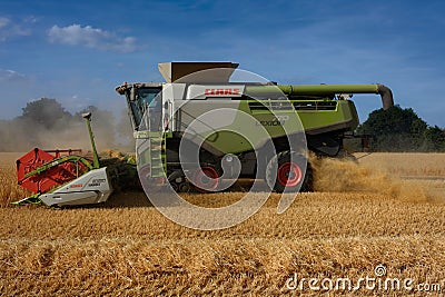 Side View of Combine Harvester Harvesting Barley in Norfolk Editorial Stock Photo