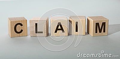 Claim word on wooden cube on gray background Stock Photo