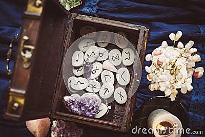 Clairvoyant tools rune stones, crystal pendulums in natural dark wooden case box. Stock Photo