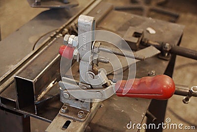 Clamp for pressing parts to the surface Stock Photo