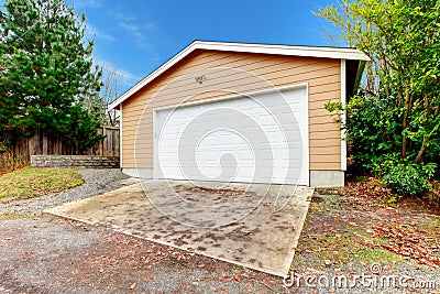 Clapboard siding garage with drive way Stock Photo