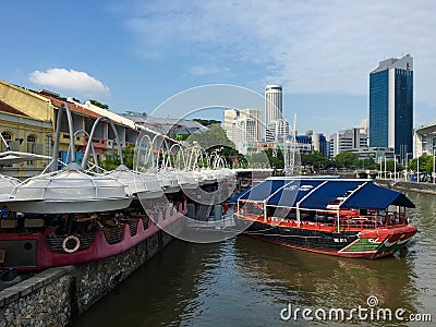 Clarke Quay marine style eatery with dining on docked boat and sailor design on Singapore River Editorial Stock Photo