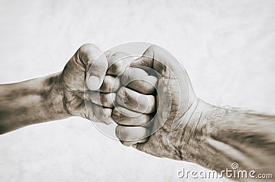 Clash of two fists on toned background. Stock Photo