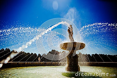 Clasic Fountain with arcing jets of water and blue sky Stock Photo
