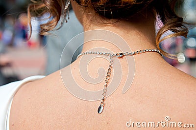 Clasp chain jewelry necklace on the neck of a young girl Stock Photo