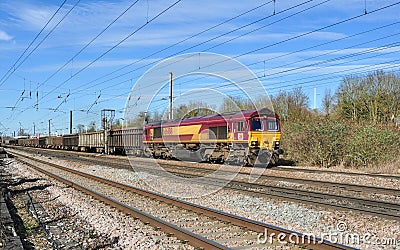 Class 66 hauls freight train through Hitchin Editorial Stock Photo