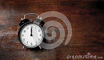 Classic alarm clock noon time on wood Stock Photo