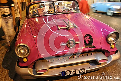 Classic American car with a picture of Che Guevara on the street of Havana, Cuba Editorial Stock Photo