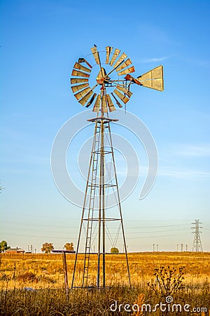 Classic Antique Rural Farm Windmill in a Field Stock Photo