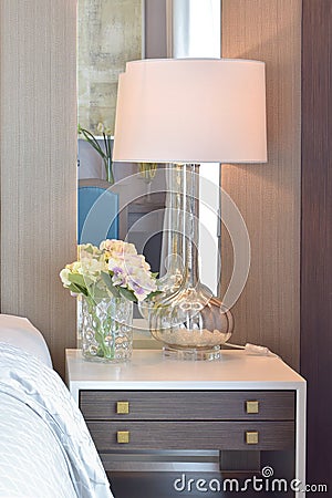 Classic bedroom interior with pillows and reading lamp on bedside table Stock Photo