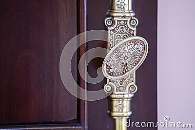 Classic brass door knob on green door vintage style. Decorative oval doorknob Stock Photo