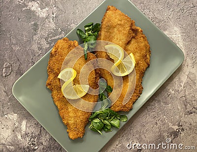 Classic breaded plaice fish fillets, coated in flour, egg, breadcrumbs and fried in oil to golden. Stock Photo