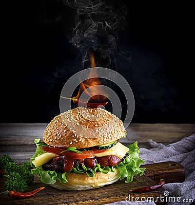 Classic burger with a meatball, cheese and vegetables, on top of Stock Photo