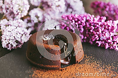 Classic chocolate fondant on a dark background with flowers Stock Photo