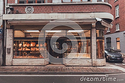 Classic Corner Building in Dinant, Belgium with Retail Storefront Editorial Stock Photo