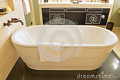 Classic design bathroom with isolated bathtub, marble wall and versace inspired cabinet door Stock Photo