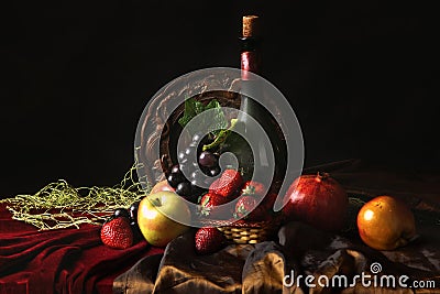 Classic Dutch still life with dusty bottle of wine and fruits on a dark background Stock Photo