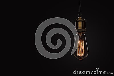 Classic Edison light bulb on black background Stock Photo