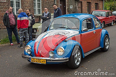 Classic funny colorful Volkswagen Beetle driving at a car show Editorial Stock Photo