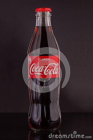 Classic glass Coca-Cola bottle with a volume of 0.33 liters isolated on a black background. Moscow, August, 2020 Editorial Stock Photo