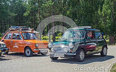 Classic green Morris Mini Cooper car driving Editorial Stock Photo