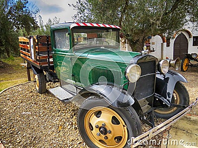 Classic green workshop van with wooden stakes parked in old colonial house Editorial Stock Photo