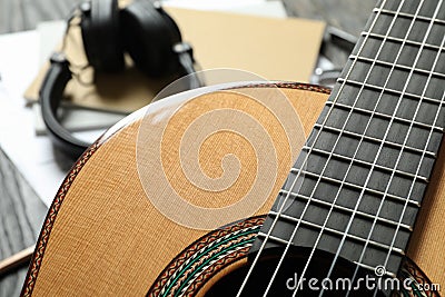 Classic guitar and music maker accessories against wooden background Stock Photo