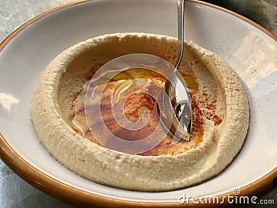 Classic Hummus / Humus with Fried Butter Sauce and Spoon. Stock Photo