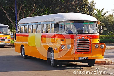 A classic iconic feature round orange Maltese public bus with shining chrome still in operation in capital city Valletta, Malta Editorial Stock Photo