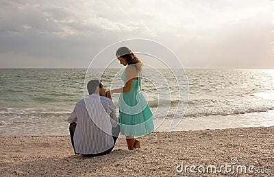 Classic image of man kissing womans hand at the be Stock Photo