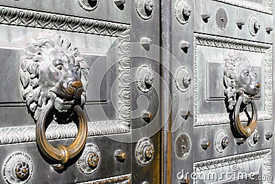 Classic iron gate with handles in the form of lion heads in the center of St. Petersburg, Russia. Stock Photo